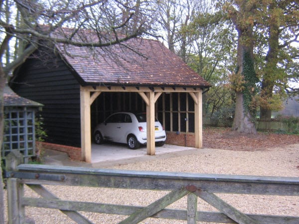 Green oak cart lodges with cedar shingles, Suffolk